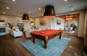 Luxe 88 Clubhouse Billiards table forefront and arcade games lounge