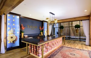Taylor House Clubhouse Entrance with Leasing Desk in forefront and climbing wall in background