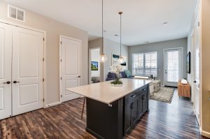 Unit B Kitchen Island in forefront with living space in backgrond