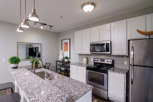 Kendall Park Model Unit Kitchen with island in forefront and dining space in background