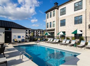 Camden Annex Pool Area with sparkling blue water and cornhole boards near Gahanna OH